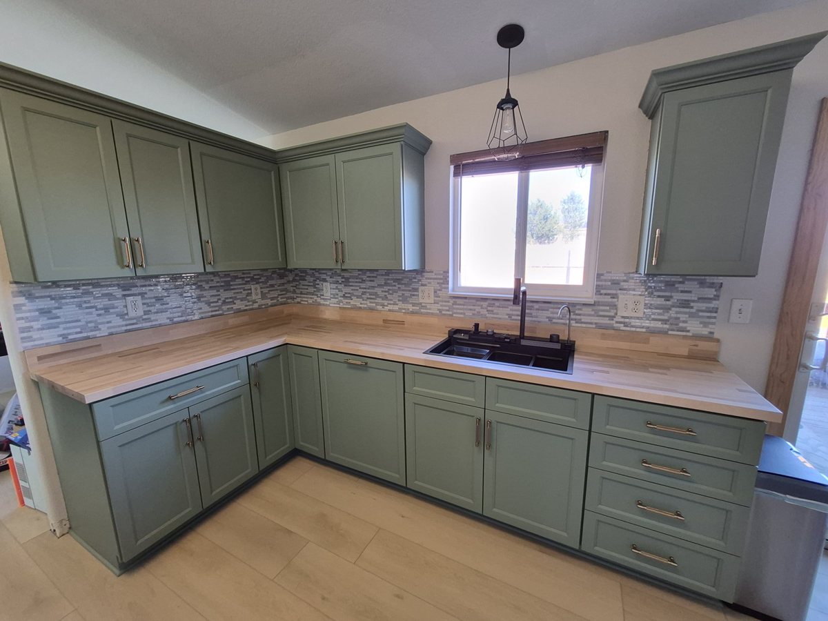 Sage green kitchen cabinets refreshed with premium coatings
